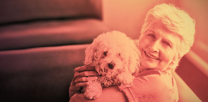 Senior woman holding a dog in a retirement home