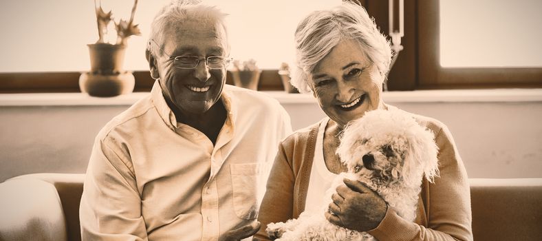 Senior couple holding a dog in a retirement home