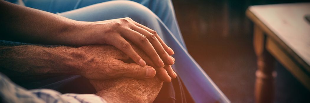 Cropped image of female doctor consoling senior man in nursing home