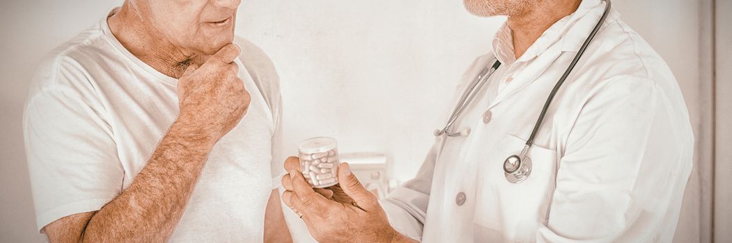 Male doctor advising senior man on medical prescriptions in hospital