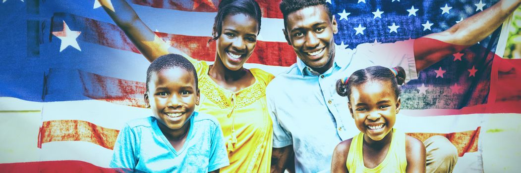 Close-up of an American flag against happy family holding american flag