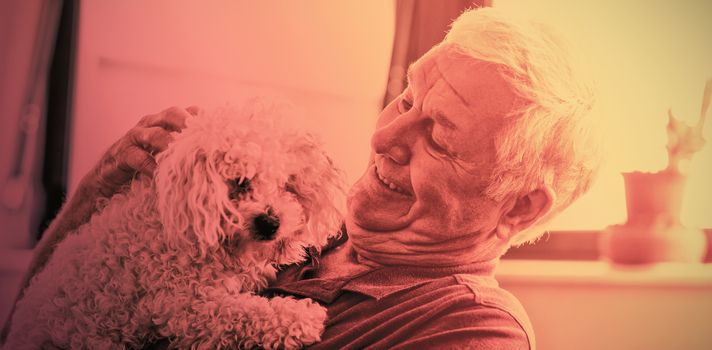 Senior man holding a dog in a retirement home