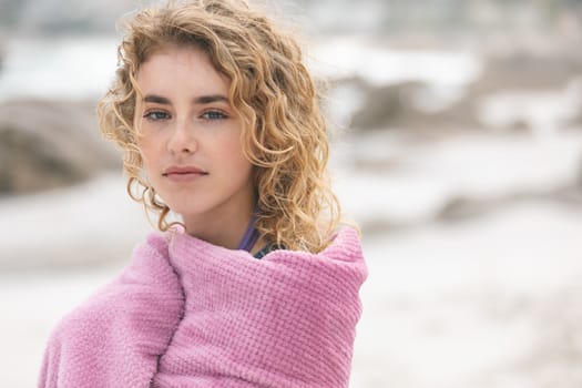 Front view of caucasian woman standing on beach while looking at camera 