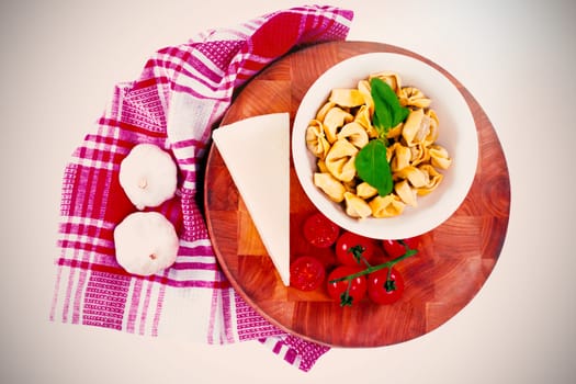 Close-up of pasta with cheese, tomatoes, garlic and napkin cloth