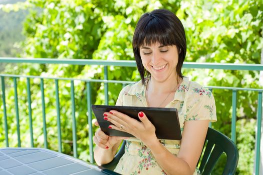 casual woman working with a tablet pc, outdoor