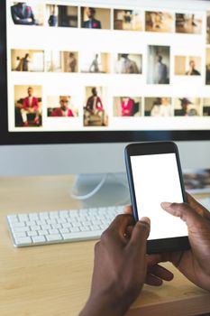 Businessman using mobile phone at desk in office