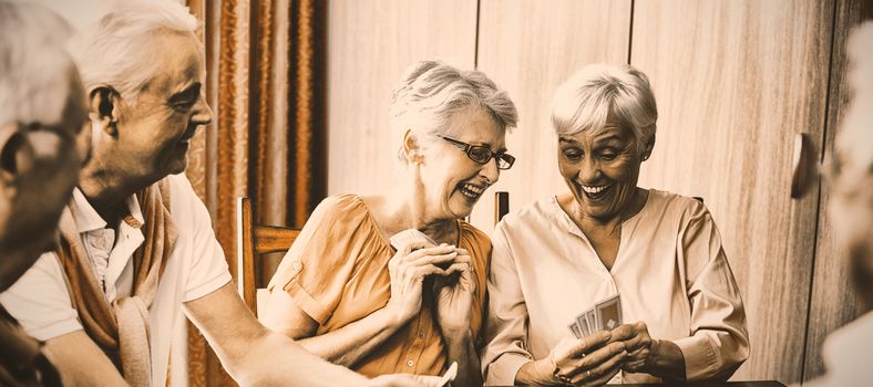 Seniors playing cards in a retirement home