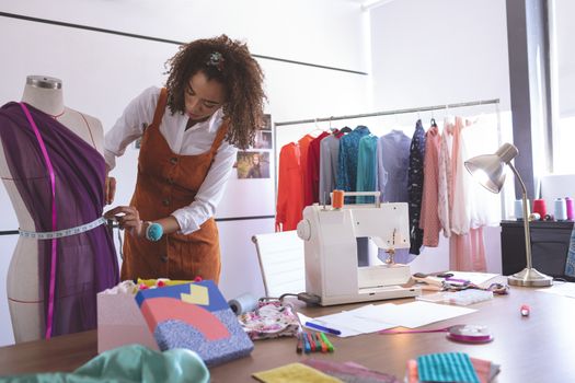 Front view of female fashion designer working in design studio