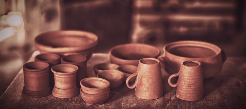 Various pottery on table in pottery workshop