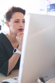 Female executive working on computer at desk in the office