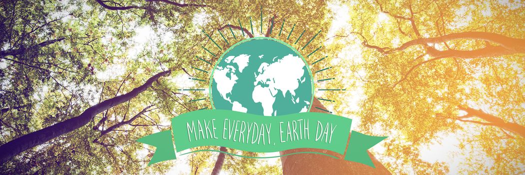 Earth Day Graphic against low angle view of tall trees
