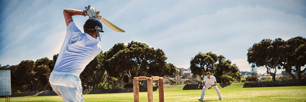 Rear view of player batting while playing cricket on field against clear sky