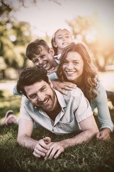 Portrait of happy family playing in park on a sunny day