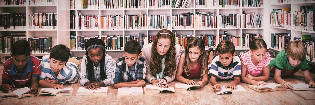 Teacher reading books to her students at school