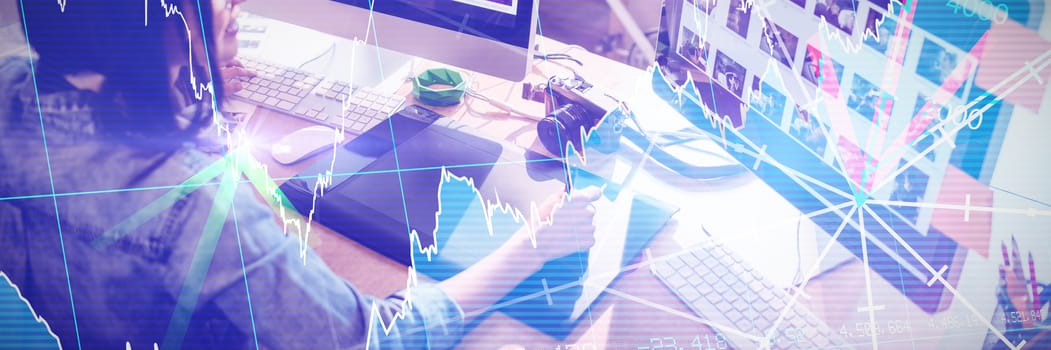 Stocks and shares against high angle view of graphic designer using graphics tablet