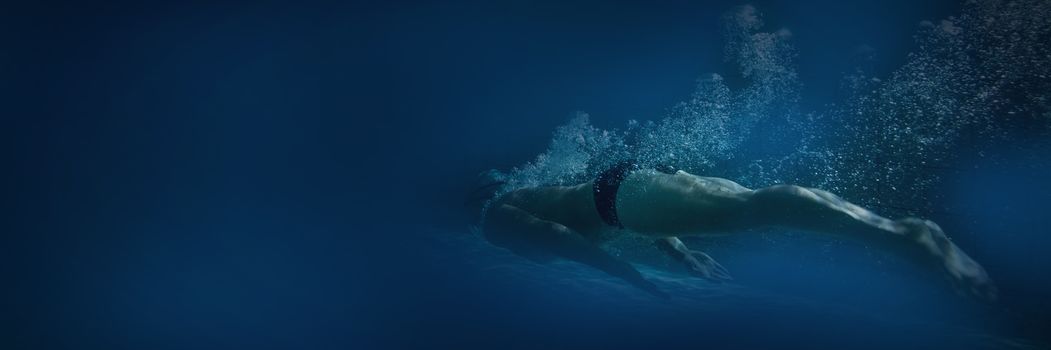 Fit swimmer training by himself in the swimming pool at the leisure centre