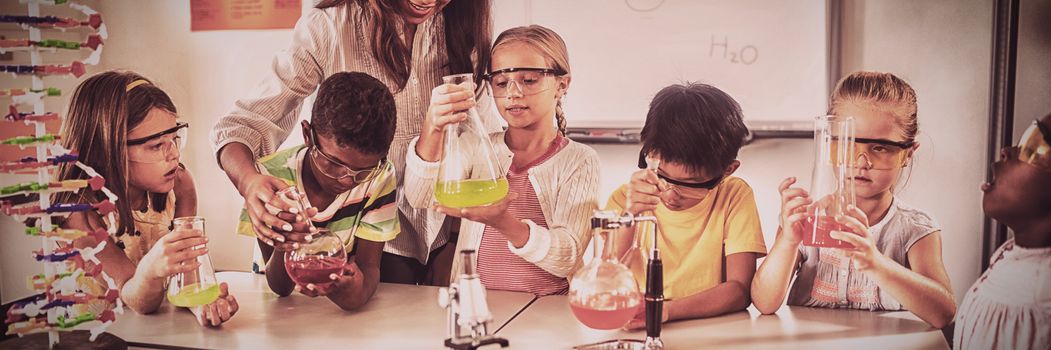 Pupils learning science with teacher in classroom