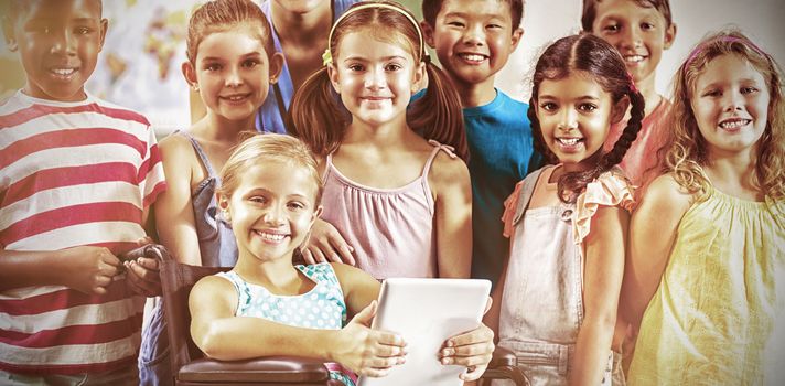 Portrait of teacher and kids in classroom at school