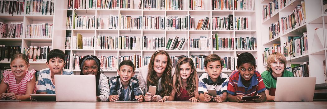 Teacher posing with her students at school