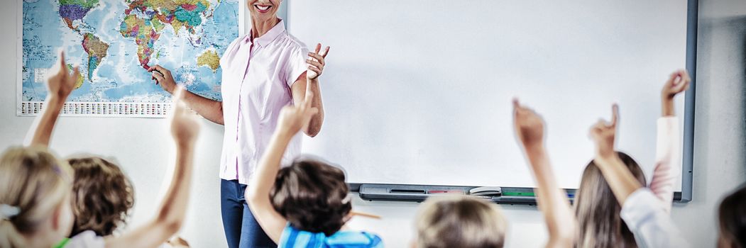 Teacher teaching kids in classroom at school