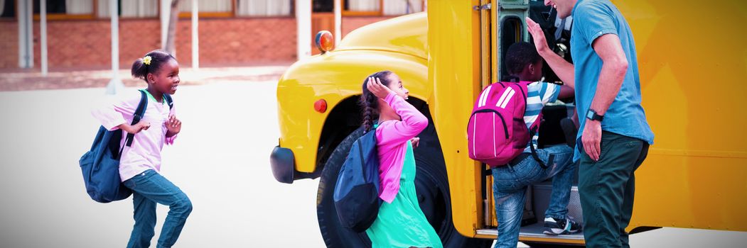 Teacher giving high five to kids while entering in bus at school