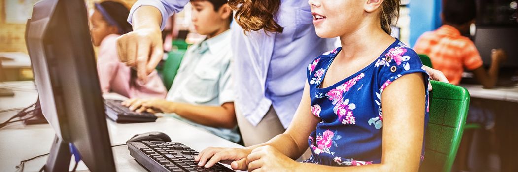 Children looking their computer at school