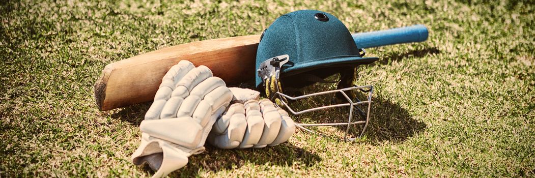 High angle view of cricket equipment on field during sunny day