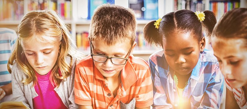 Kids reading a book in library at school