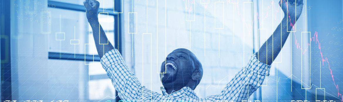 Stocks and shares against excited man sitting on table with digital tablet and laptop