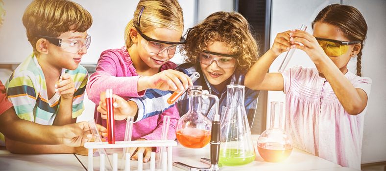 Kids doing a chemical experiment in laboratory at school