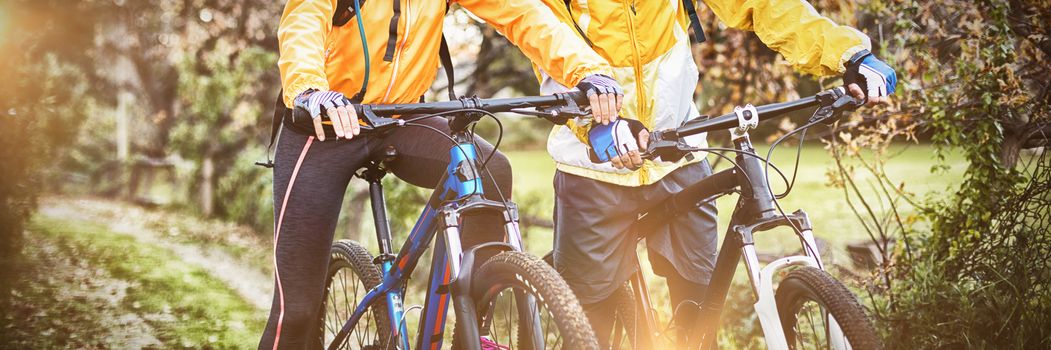 Biker couple cycling together in countryside