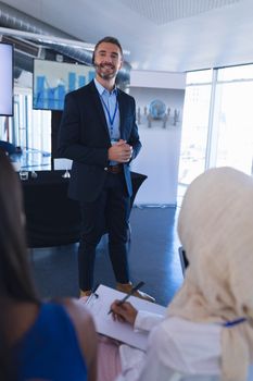 Portrait of caucasian male speaker speaks in business seminar at conference meeting. International diverse corporate business partnership concept