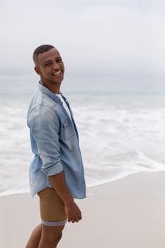 Portrait of happy African american man standing on the beach