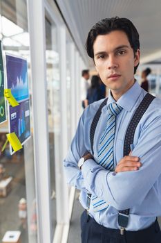 Portrait of caucasian Businessman standing with arms crossed in office. International diverse corporate business partnership concept