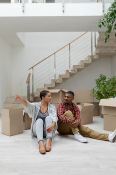 Front view of happy African american couple interacting with each other in living room at home