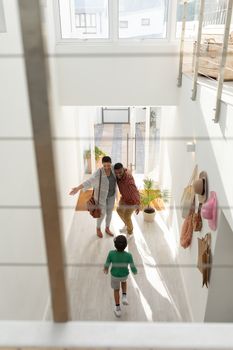 High angle view of Happy African american parents embracing their son while entering at home