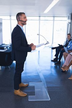 Side view of Caucasian Male speaker speaks in business seminar at conference meeting. International diverse corporate business partnership concept