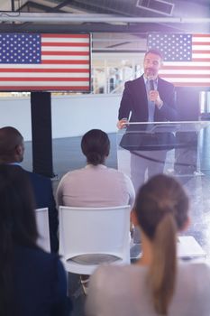 Front view of Male speaker speaks in a business seminar at conference meeting. International diverse corporate business partnership concept