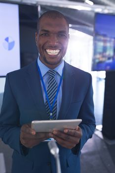 Front view of Happy African-american male speaker practicing his speech on digital tablet in business seminar. International diverse corporate business partnership concept