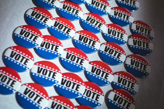 Electoral pins in the colors of the US flag on table