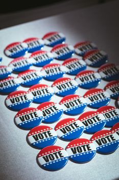 Electoral pins in the colors of the US flag on table