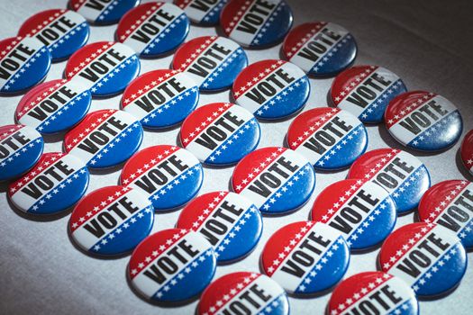 Electoral pins in the colors of the US flag on table