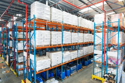 High angle view of barrel and goods arranged on a rack in warehous. This is a freight transportation and distribution warehouse. Industrial and industrial workers concept