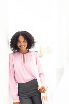 Front view of young pretty African-american employee looking at camera