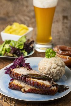 portion of fresh roasted pork on a blue plate