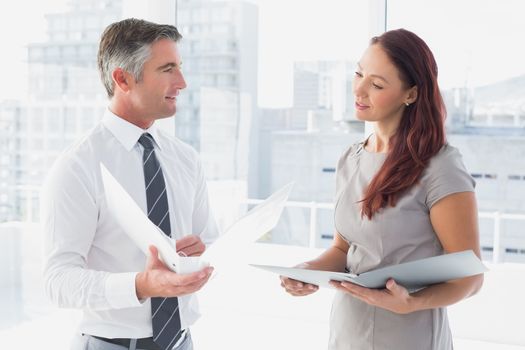 Business people smiling and talking at work