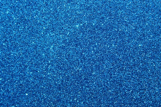 The picture shows a background with blue glittery paper