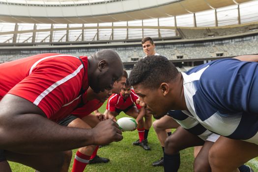 Side view of diverse male rugby players looking into the eyes of the competitors.
