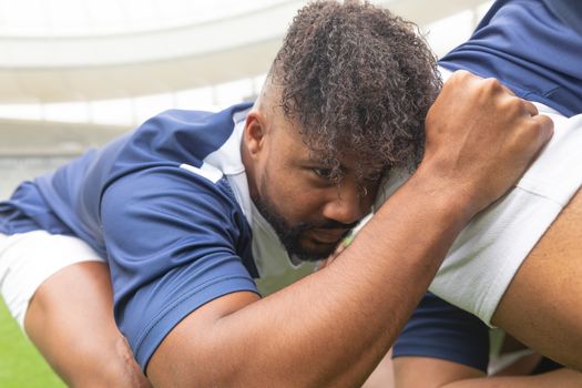 Side view of young African American male rugby players ready to play rugby match in stadium