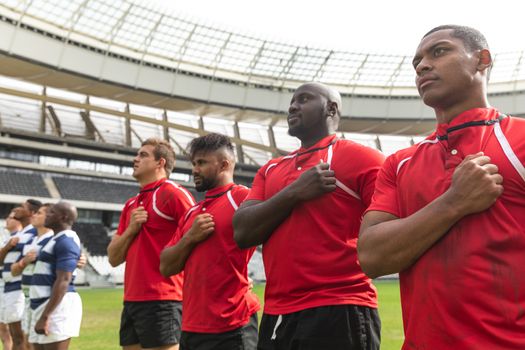 Front view of proud diverse rugby team taking pledge together in stadium